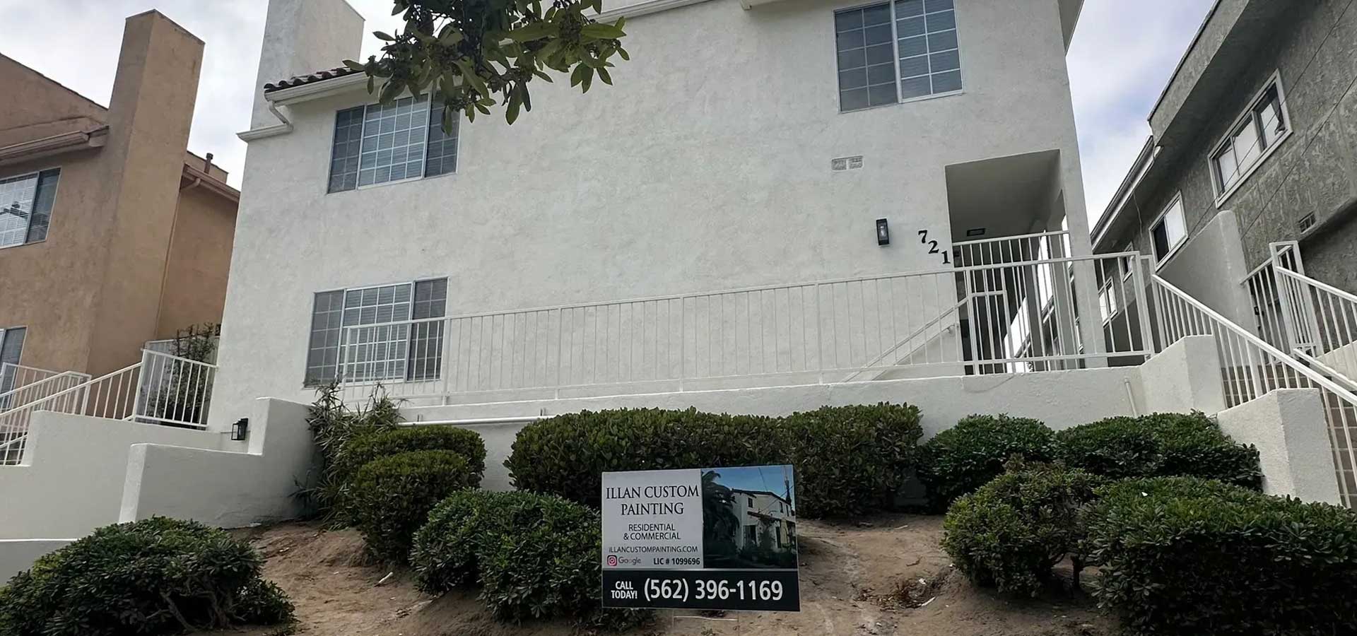 a white house with Illan Custom Painting sign in Los Angeles