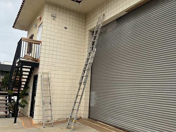 a building with a large window and a ladder in Hollywood