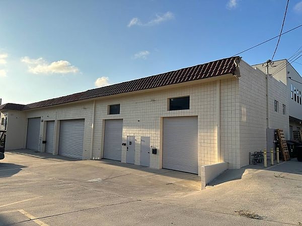 a white building with a black door near Burbank